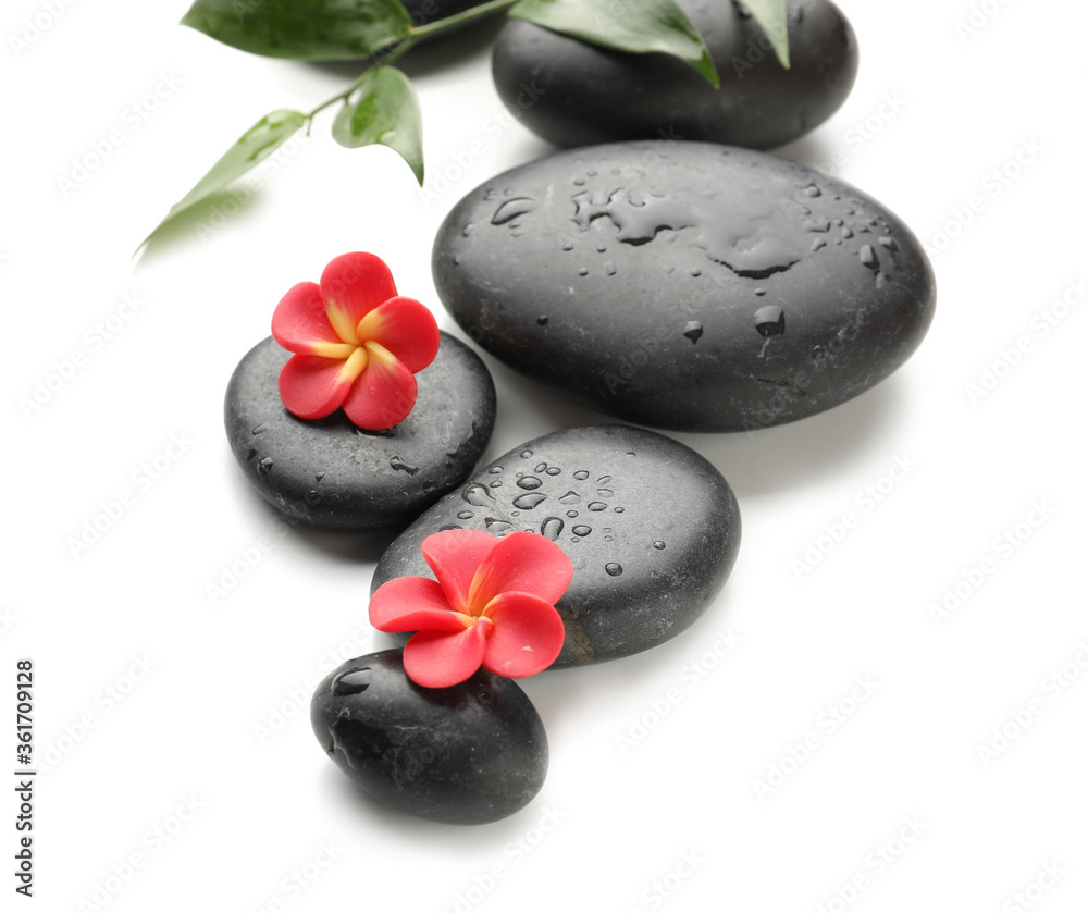 Spa stones and flowers on white background