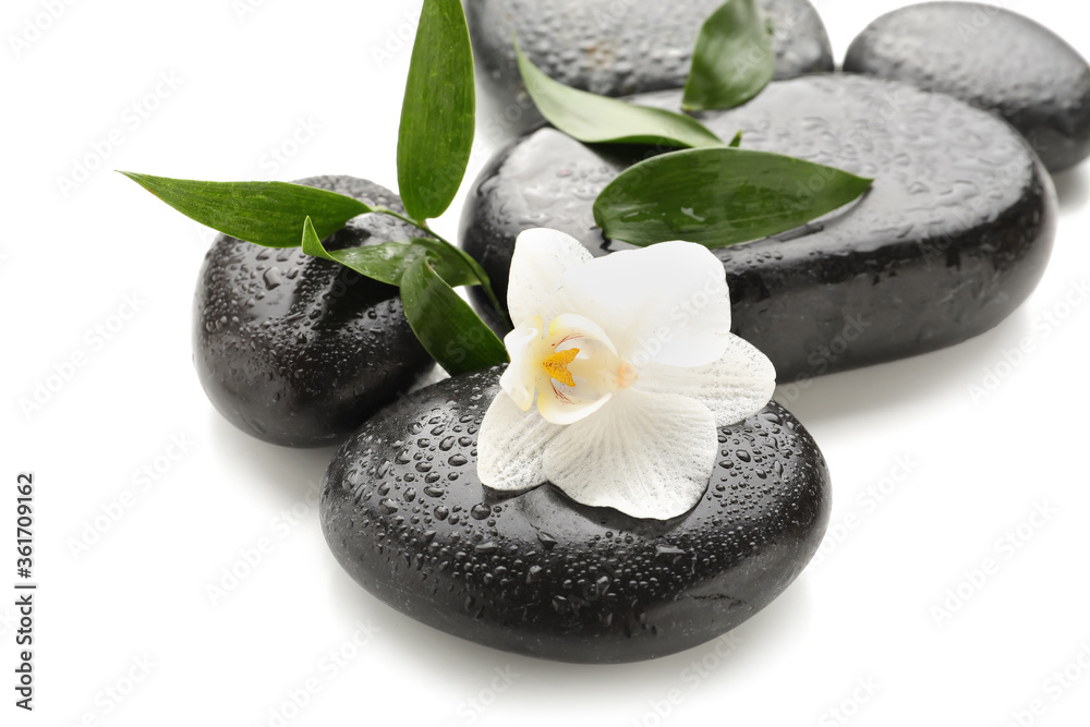 Spa stones and flower on white background