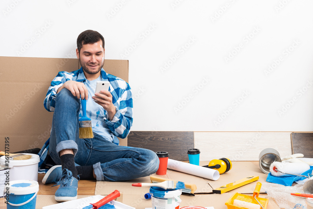 Smiling man surfing internet on mobile phone