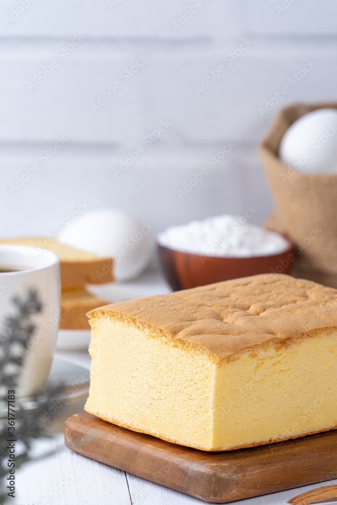 Plain classic Taiwanese traditional sponge cake (Taiwanese castella kasutera) on a wooden tray backg