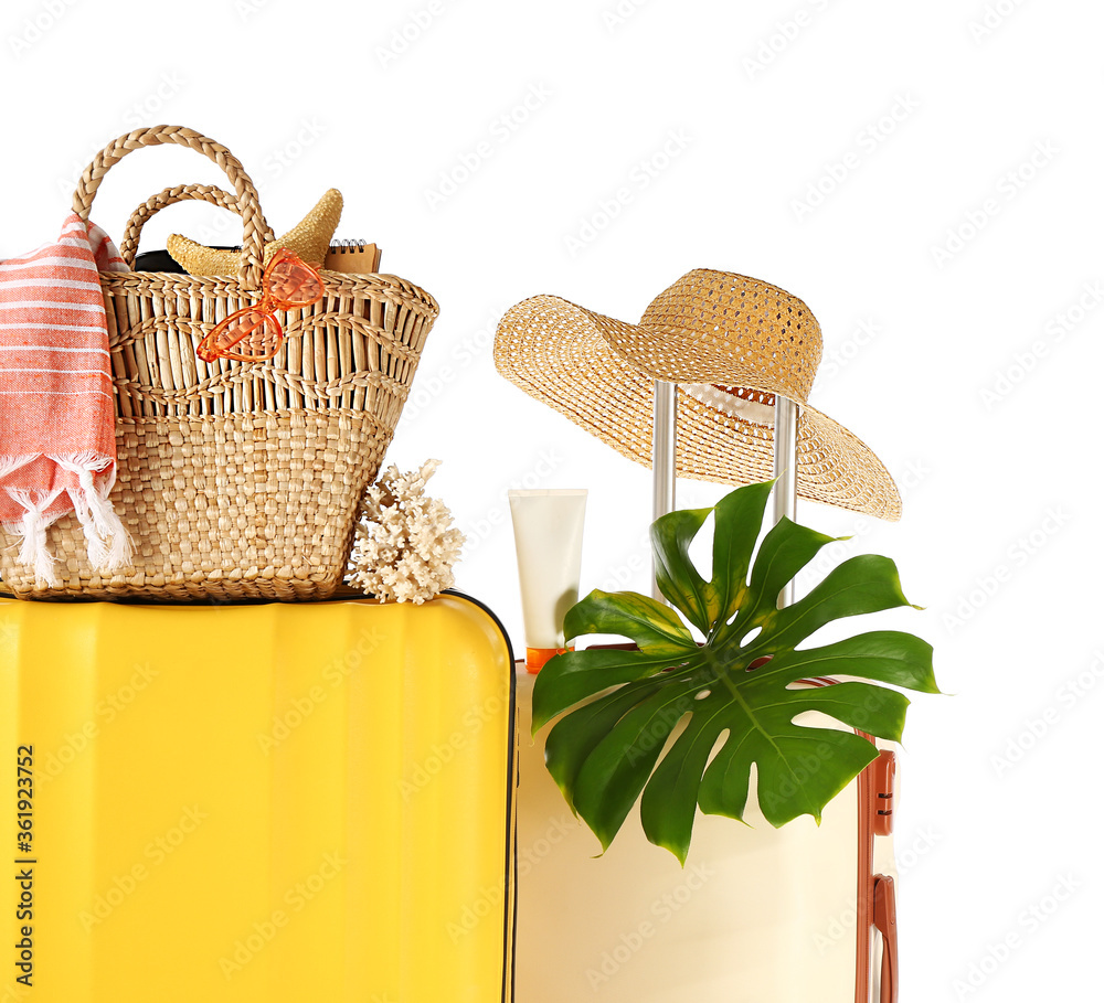 Packed suitcases with beach accessories on white background. Travel concept