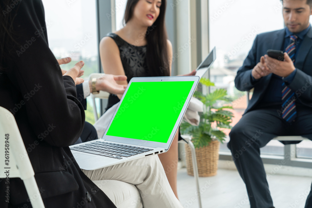 Business people in the conference room with green screen chroma key TV or computer on the office tab