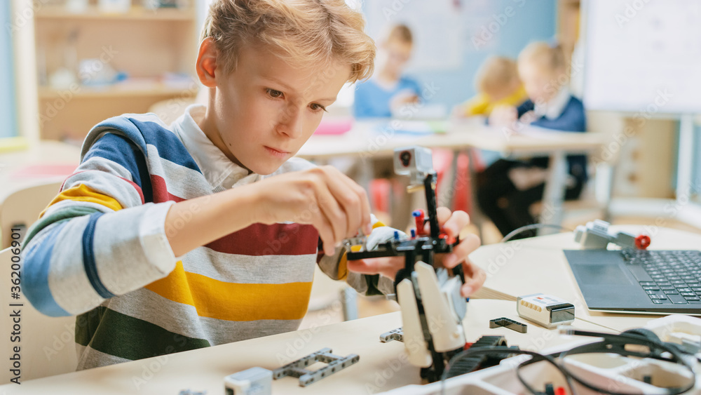 Schoolboy Builds / Constructs Small Robot and Uses Laptop to Program Software for Robotics Engineeri