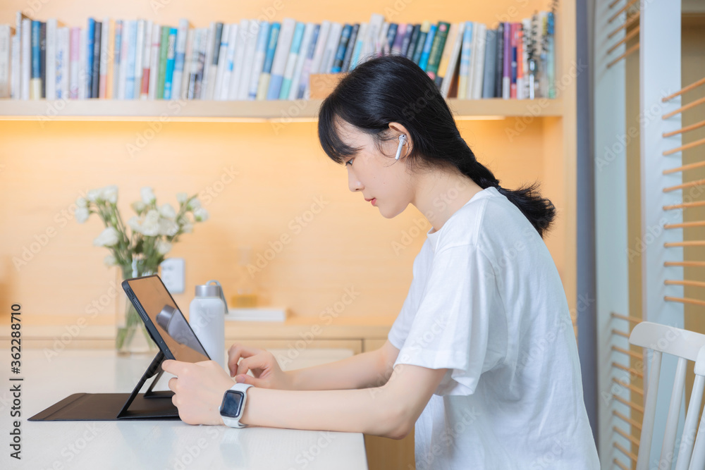 In the study, a pure girl using tablet