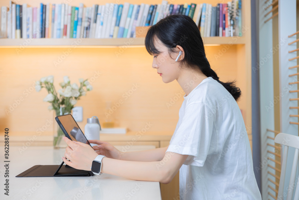 In the study, a pure girl using tablet