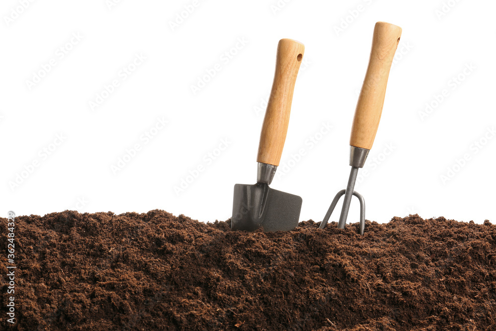 Soil and gardening tools on white background