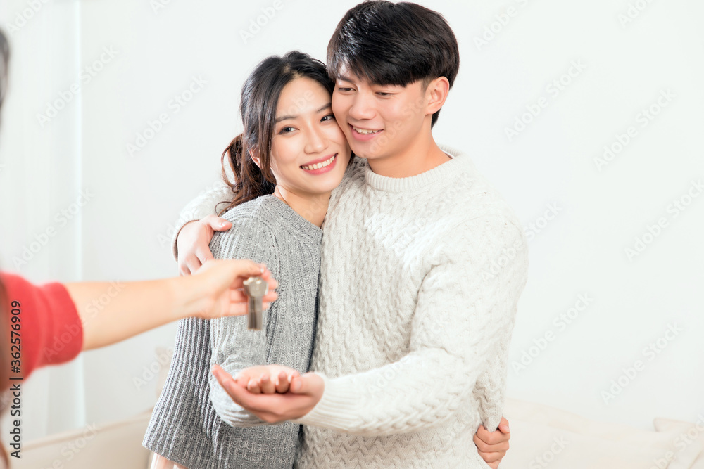 A pair of intimate young Asian lovers enter their new house with their keys