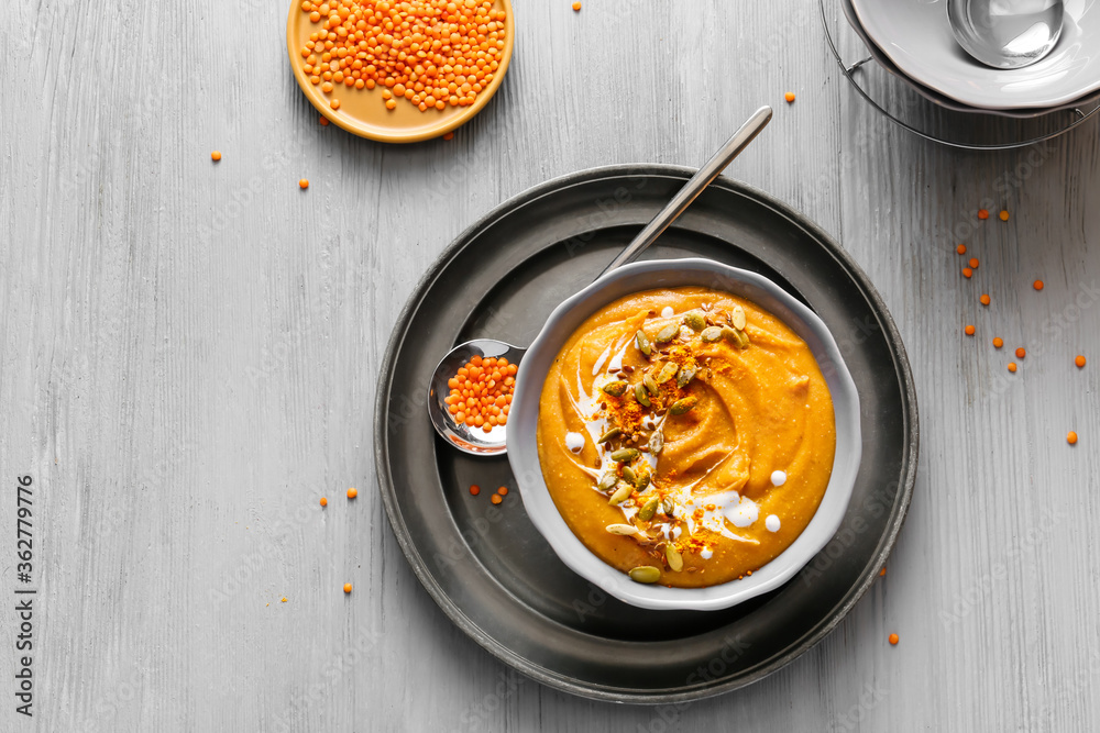 Bowl of tasty lentils soup on table