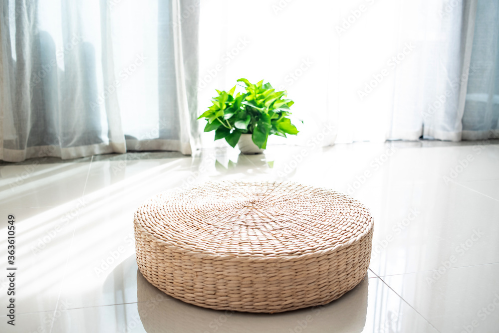 A futon on the ground by the indoor window