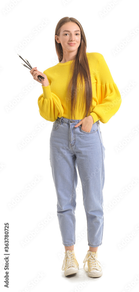 Young female calligraphist on white background