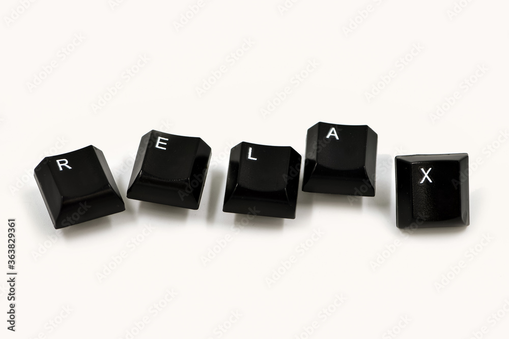 Word laid out from the keyboard keys on a white background. Relax word written with computer buttons