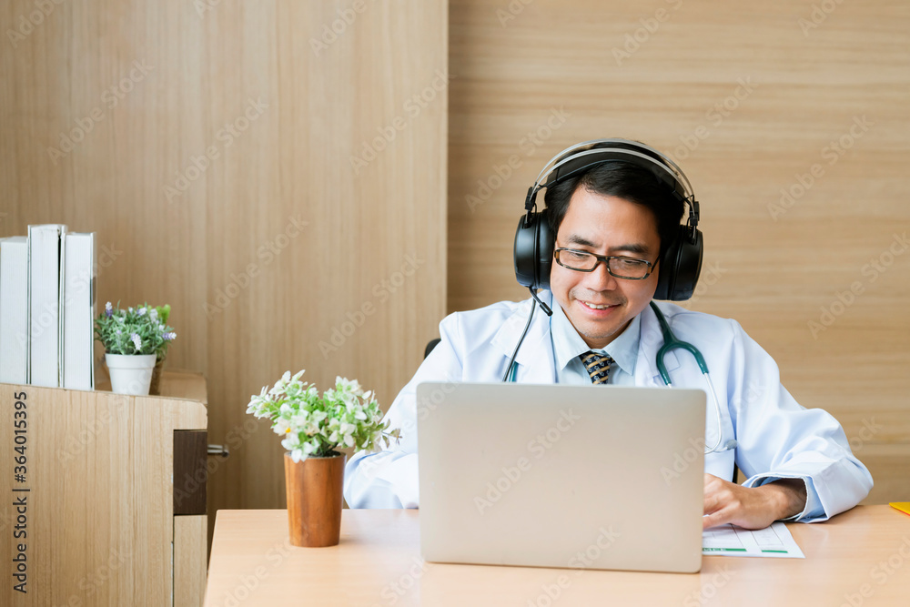 Young attractive Asian male doctor diagnosis talking and looking to camera in video conference ,Posi