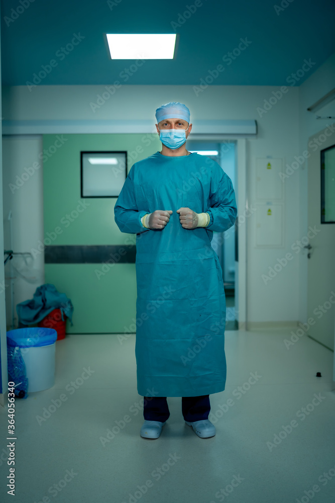 Portrait of a doctor or medical specialist. Vertical portrait. Man in scrubs. Light background with 