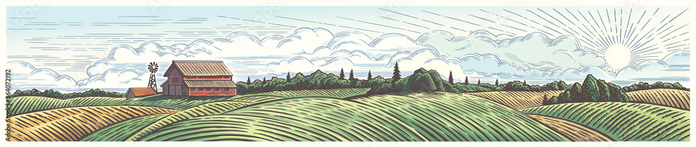 Rural landscape, panoramic format with a farm with and agricultural fields around.