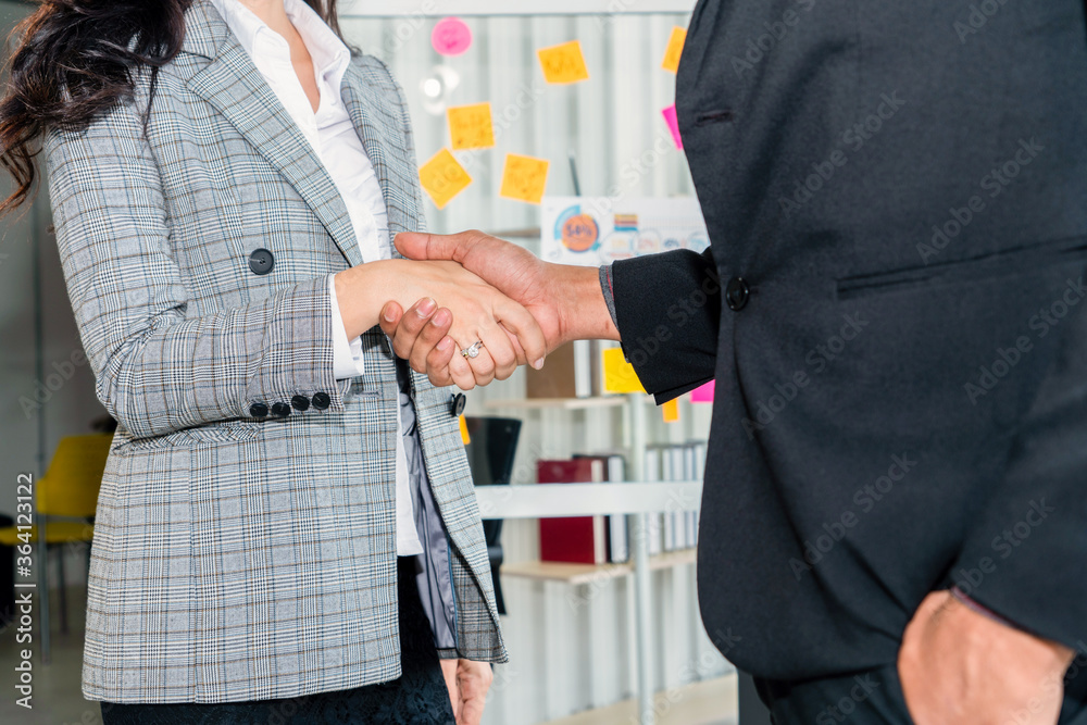 Business people handshake in corporate office showing professional agreement on a financial deal con