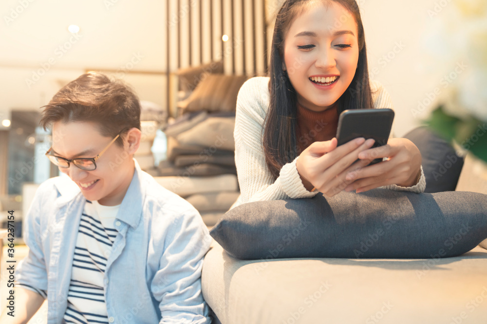 asian marry sweet romance couple family both enjoy pravate technology smartphone and laptop together