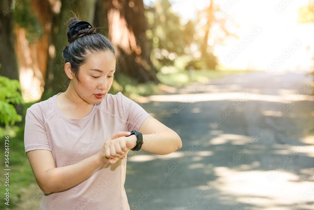 Young Asian woman doing running exercises in the nature park, Exercise for health or warm-up body, f