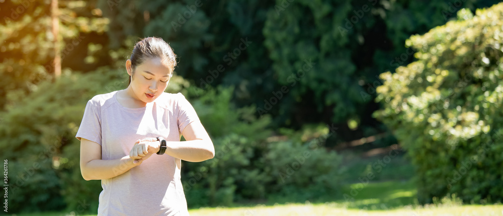 Young Asian woman doing running exercises in the nature park, Exercise for health or warm-up body, f