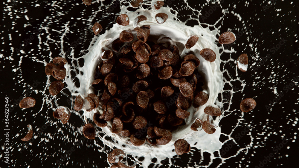 Freeze motion of rotating cereal pieces with milk splash