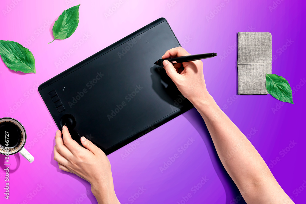 Person using a graphic pen tablet - flat lay