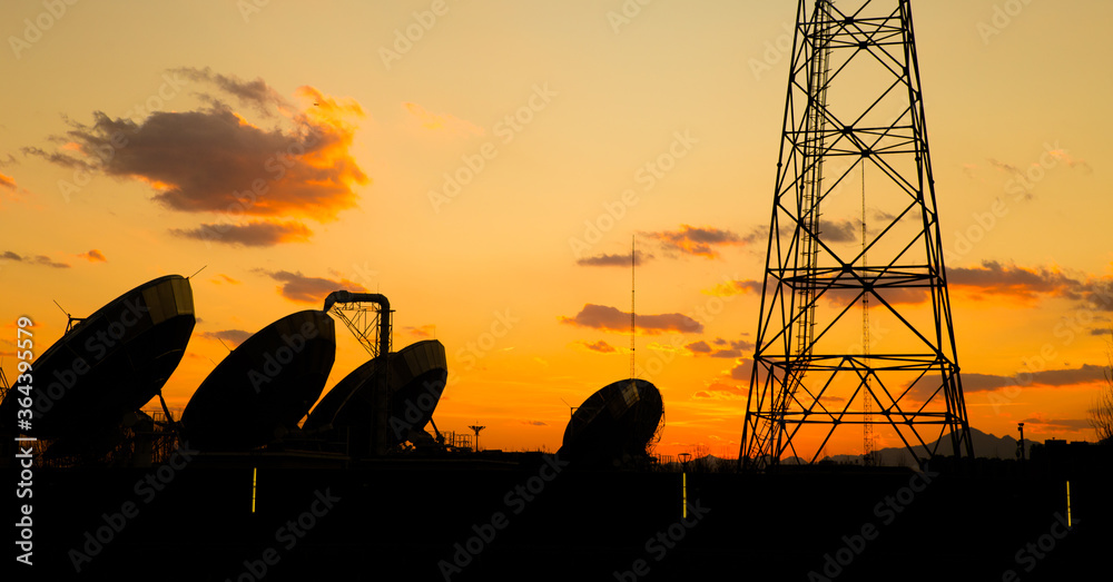 antenna and base station silhouette at sunset