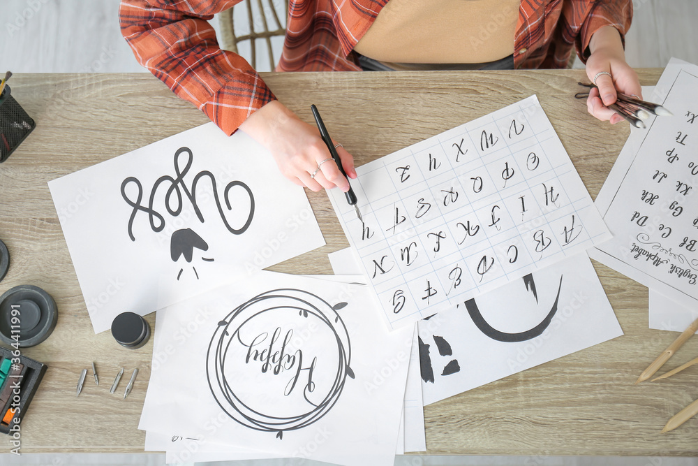 Female calligraphist working in office