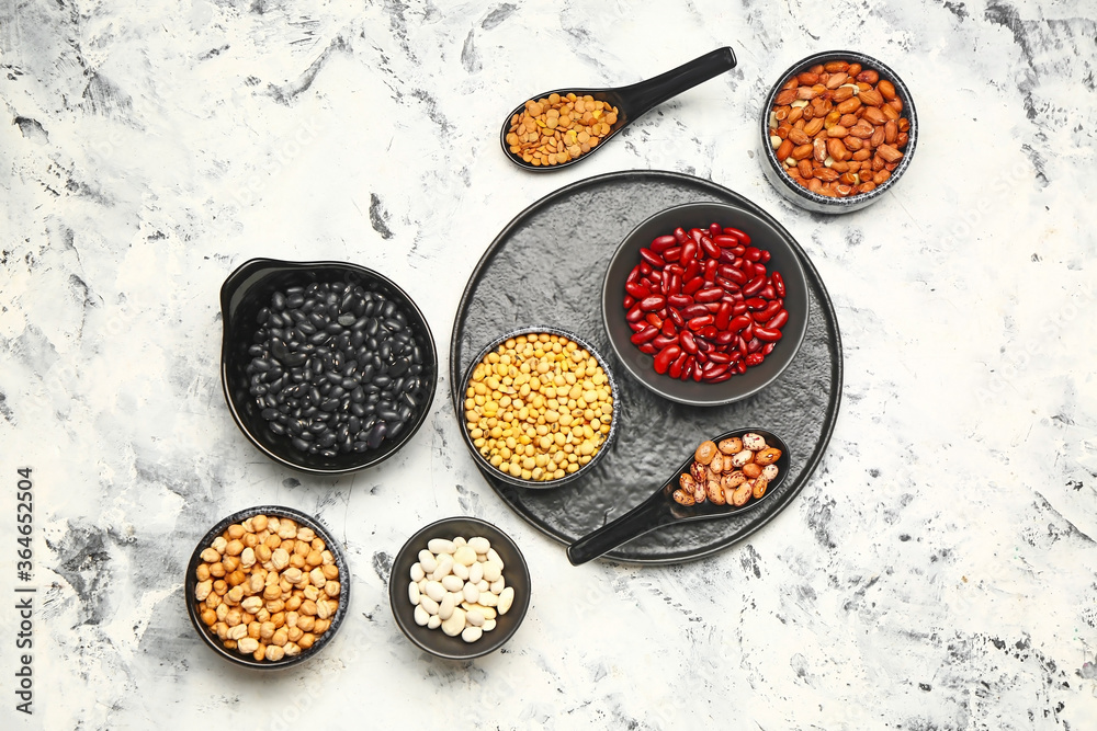 Different raw legumes on white background