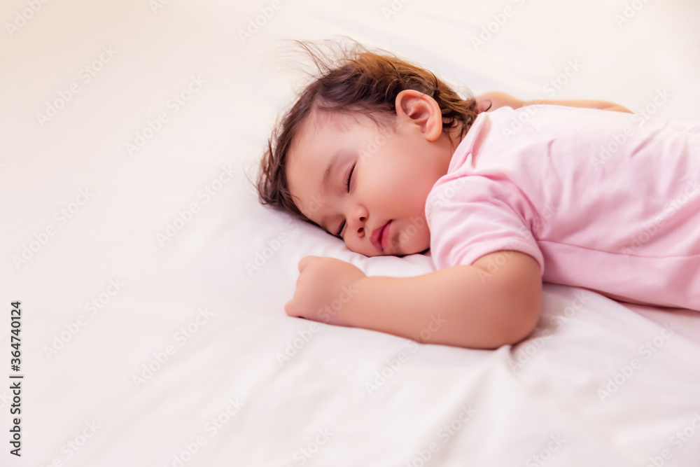 Adorable innocent baby girl sleeping on bed with good dream. Cute mixed race infant baby get deep sl