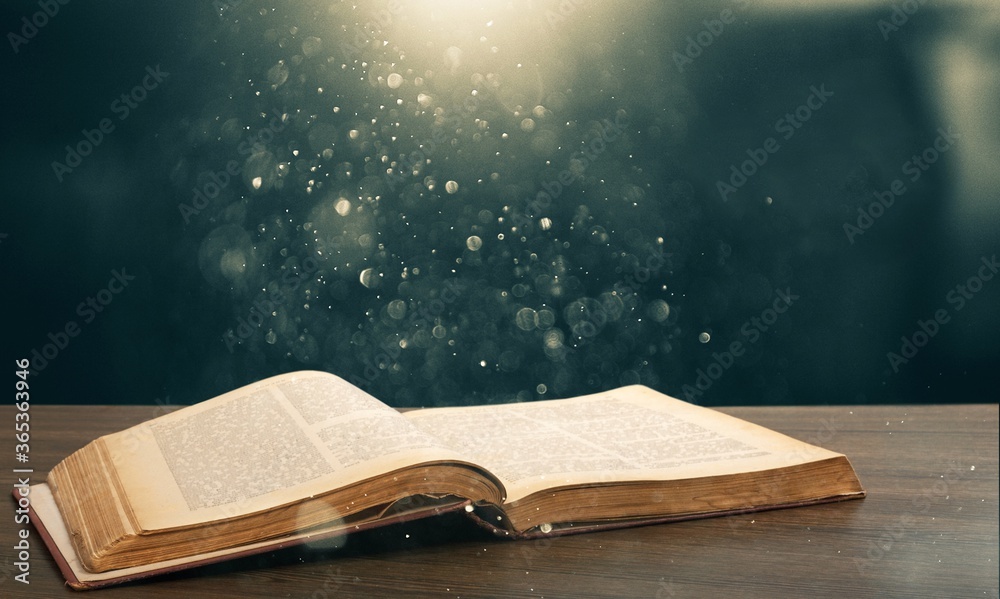 Open book on old wooden table