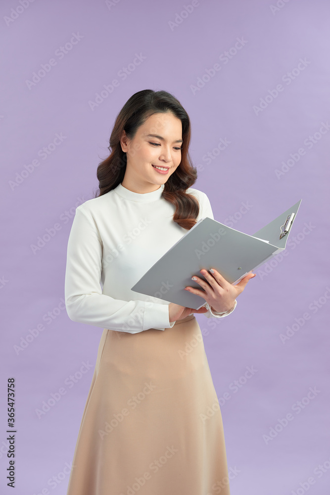 Portrait of young pretty positive girl smiling looking at camera with crossed arms over purple backg