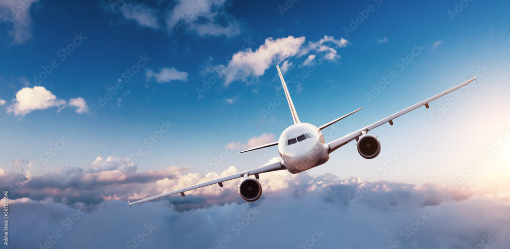 Commercial airplane flying above clouds