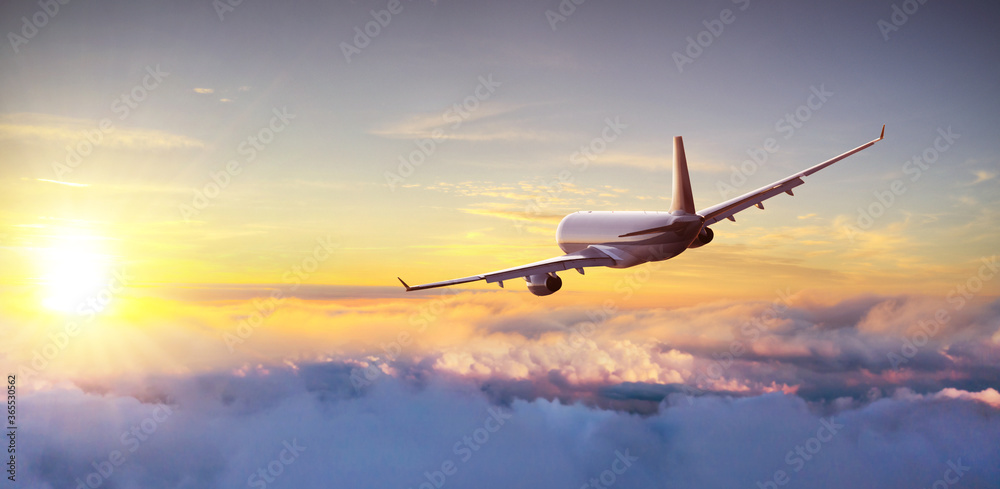 Commercial airplane flying above clouds