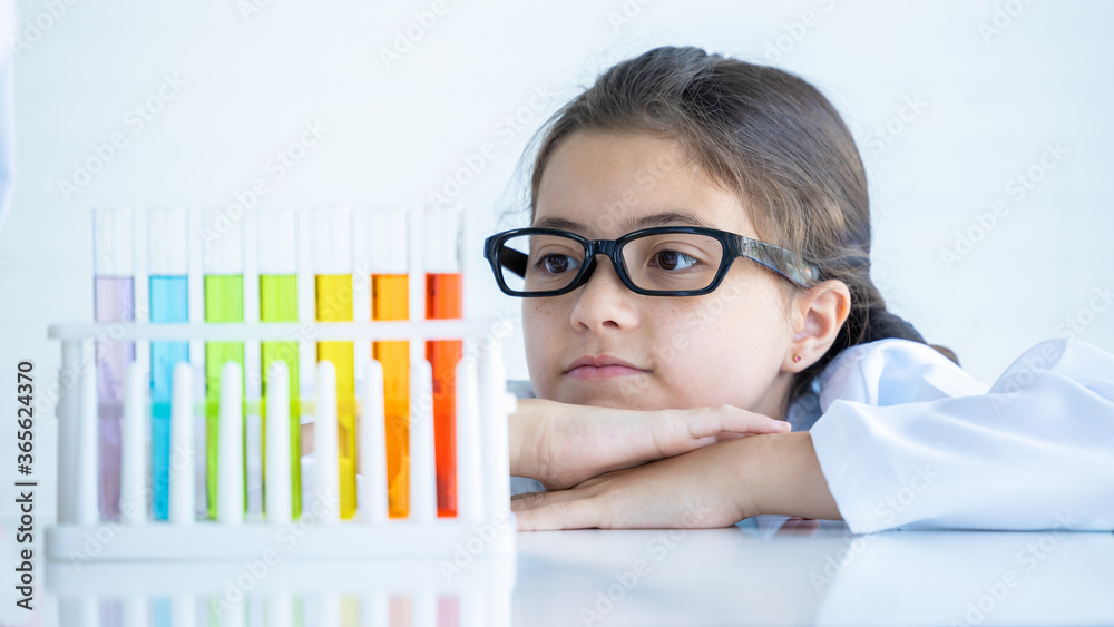 Kid in lab coat learning chemistry in school laboratory, Kid scientist studying science, experimenti