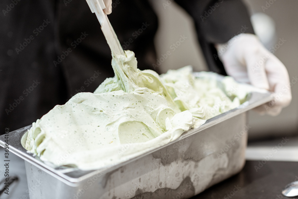 A pile of ready-made ice cream in the metal tray, close-up