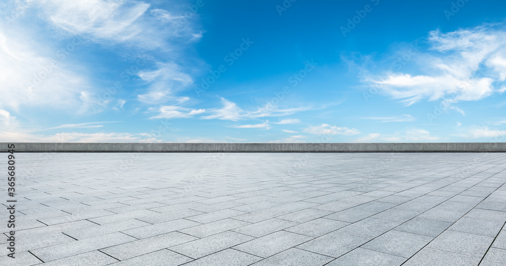 Empty square floor and blue sky with white clouds scene.