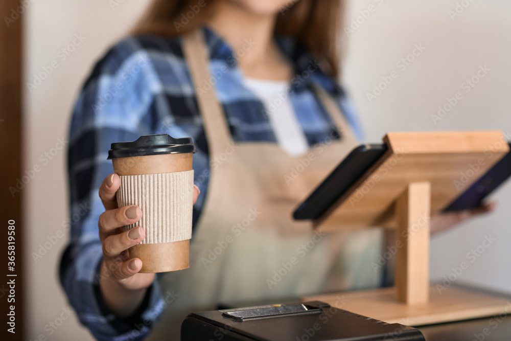 Female barista in modern cafe