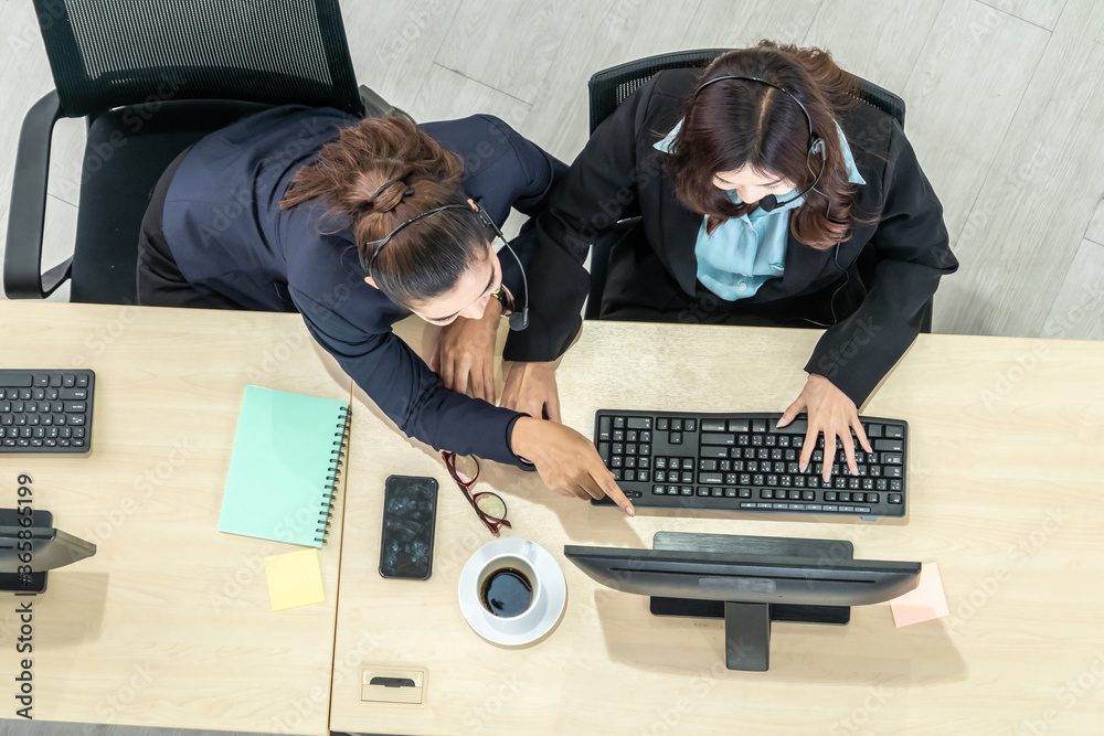 Business people wearing headset from top view in office working with computer to support remote cust