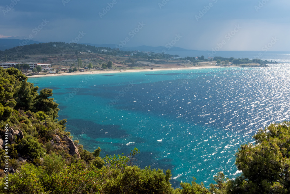 Landscape with beach, the sea and the clouds in the blue sky