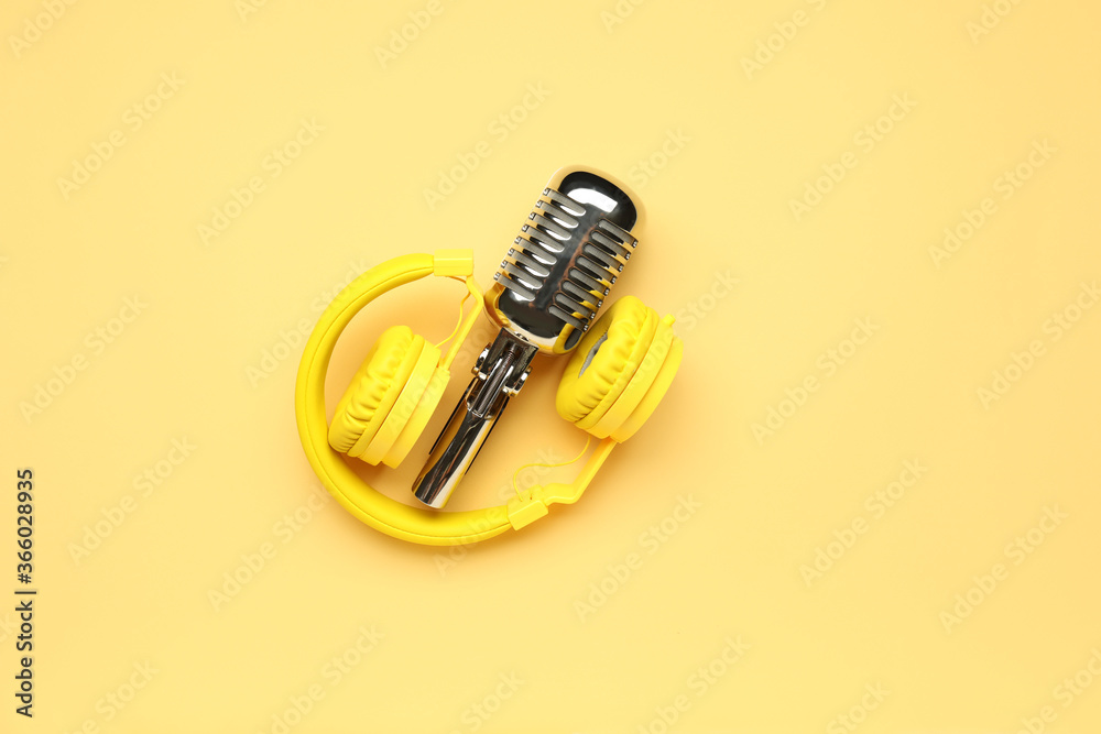 Headphones with microphone on color background