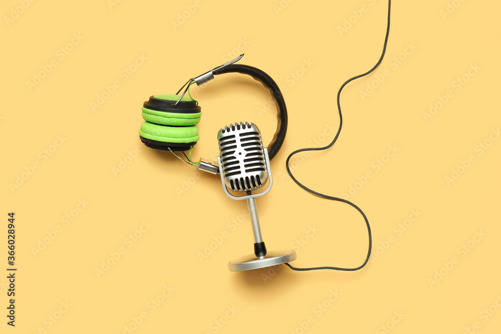 Headphones with microphone on color background