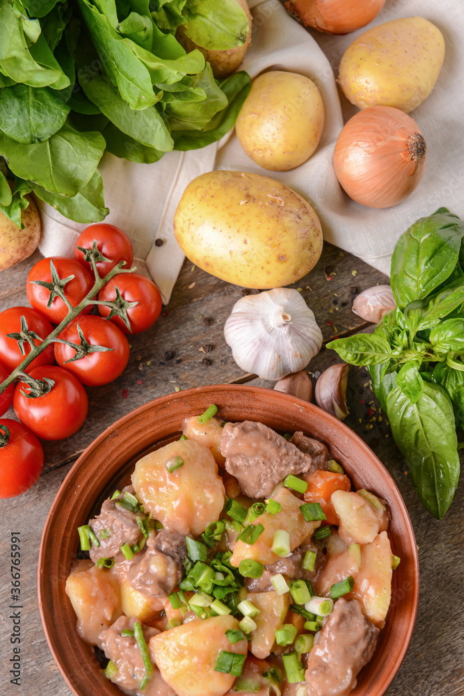 Bowl with tasty beef stew on table