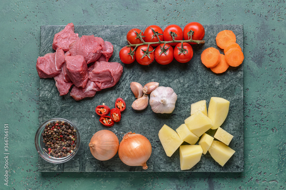 Ingredients for tasty beef stew on color background