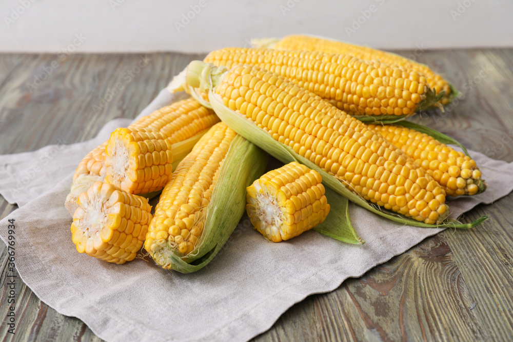 Fresh corn cobs on table