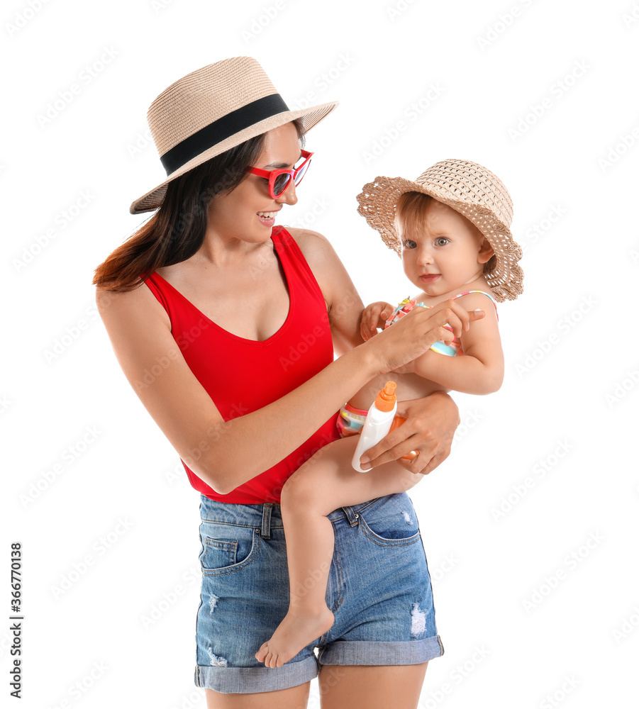 Mother and her little daughter with sunscreen cream on white background