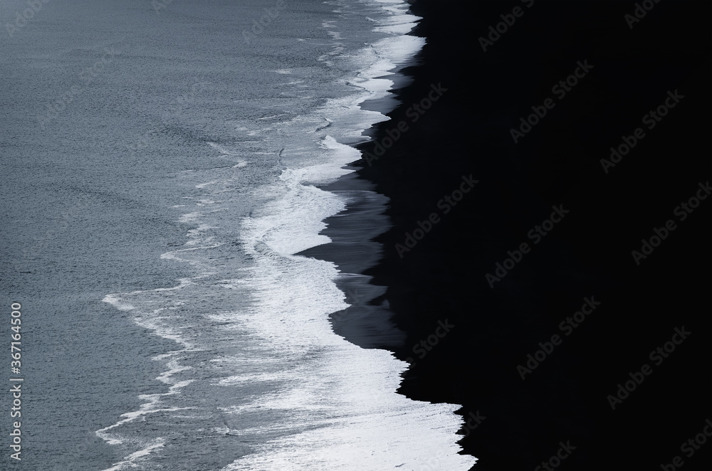 Iceland. View on the black coast line and wave. Beach and sea from high rock. Famous place in Icelan