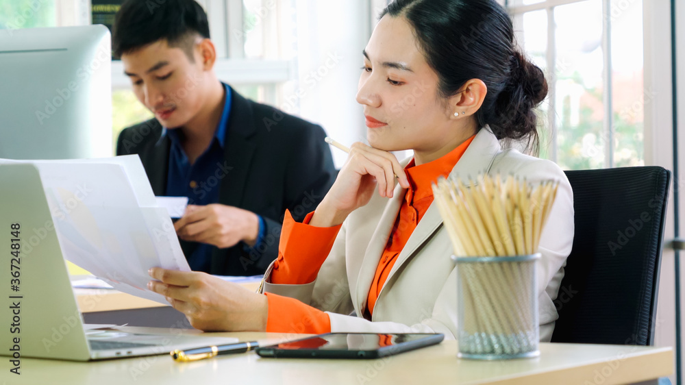 Business people working at table in modern office room while analyzing financial data report .