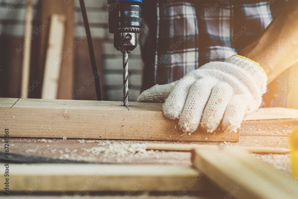 Carpenter working on wood craft at workshop to produce construction material or wooden furniture. Th