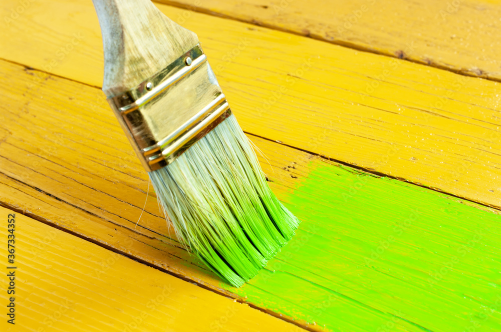 Paint brush on wooden surface