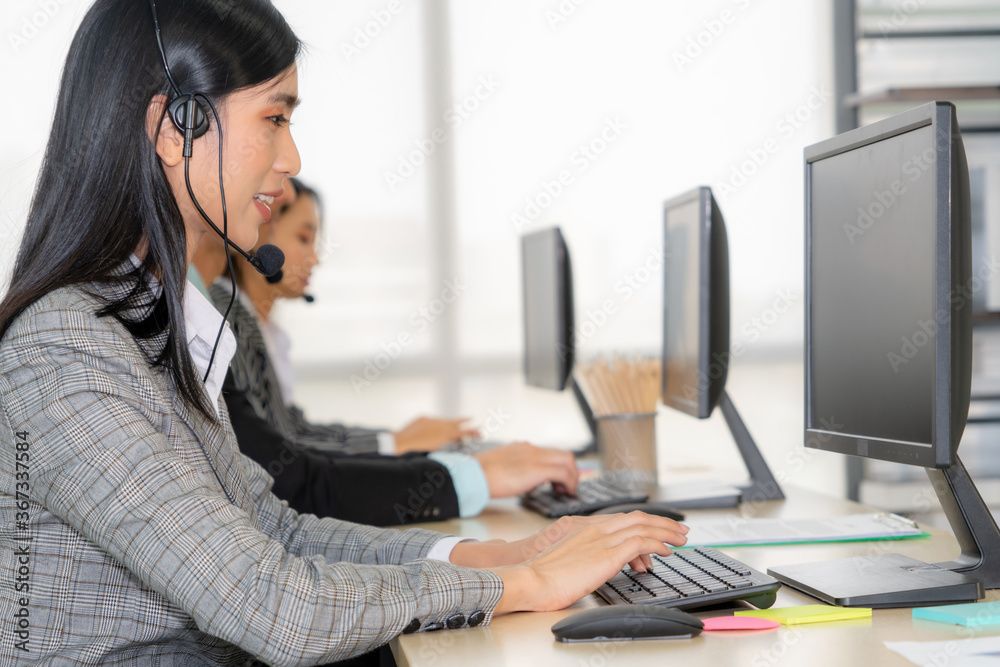 Business people wearing headset working in office to support remote customer or colleague. Call cent