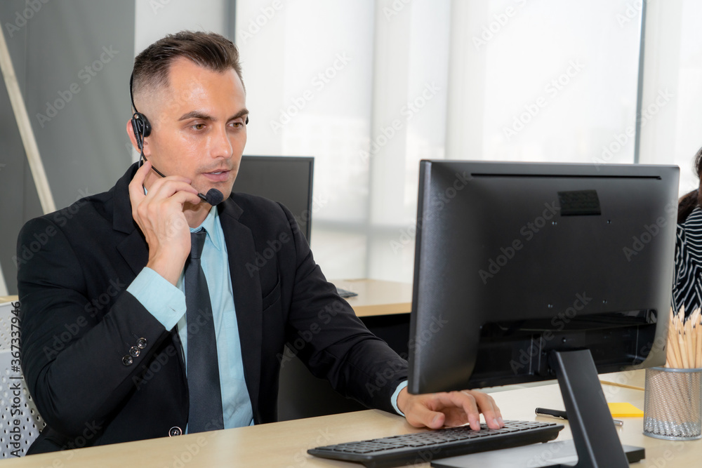 Business people wearing headset working in office to support remote customer or colleague. Call cent